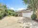 Spacious two-car garage with solar panels on the roof and a long driveway for extra parking at 3158 Forest Breeze Way, St Cloud, FL 34771