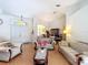 Open-concept living room with lots of light and a view into the dining area with a chandelier at 3158 Forest Breeze Way, St Cloud, FL 34771