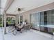 Relaxing covered patio with comfortable lounge chairs overlooking backyard pool and landscaping at 3158 Forest Breeze Way, St Cloud, FL 34771