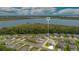 Stunning aerial view of a home in a vibrant community with a beautiful lake backdrop and lush green surroundings at 31792 Broadwater Ave, Leesburg, FL 34748