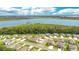 An expansive aerial showcases a neighborhood bordering a lake, offering scenic views at 31792 Broadwater Ave, Leesburg, FL 34748