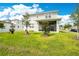 Backyard featuring a well-maintained lawn and screened-in patio at 31792 Broadwater Ave, Leesburg, FL 34748
