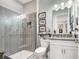 Bathroom with modern gray herringbone tiling in shower and vanity with framed art at 31792 Broadwater Ave, Leesburg, FL 34748