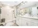 Modern bathroom with double sinks, vanity, large mirror and glass shower at 31792 Broadwater Ave, Leesburg, FL 34748