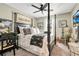 Well-lit bedroom featuring a stylish four-poster bed with Parisian themed decor and a ceiling fan at 31792 Broadwater Ave, Leesburg, FL 34748