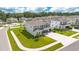Aerial view of a two-story home with a well-manicured lawn and multi-car driveway at 31792 Broadwater Ave, Leesburg, FL 34748