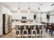 Modern kitchen with stainless steel appliances, white cabinetry and a large center island at 31792 Broadwater Ave, Leesburg, FL 34748