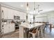 Modern kitchen with stainless steel appliances, white cabinets, a large island, and barstool seating at 31792 Broadwater Ave, Leesburg, FL 34748