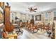 Charming living room with hardwood floors, beautiful curtains, ceiling fan, and a sitting area at 31792 Broadwater Ave, Leesburg, FL 34748