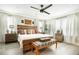 Spacious main bedroom boasts a stylish ceiling fan, windows and hardwood floors at 31792 Broadwater Ave, Leesburg, FL 34748