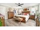 Spacious main bedroom boasts hardwood floors, stylish ceiling fan, windows and ensuite at 31792 Broadwater Ave, Leesburg, FL 34748