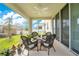 Covered patio featuring wicker chairs and scenic views at 31792 Broadwater Ave, Leesburg, FL 34748