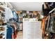 Walk-in closet includes custom shelving, multiple hanging racks, and center storage island at 31792 Broadwater Ave, Leesburg, FL 34748