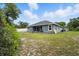 Large backyard of a single-story home, featuring a lawn and privacy fence, perfect for outdoor activities at 3390 George Sauls St, Deltona, FL 32738