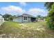 Large backyard with a view of the house, featuring green grass and a fence at 3390 George Sauls St, Deltona, FL 32738