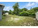 Spacious backyard featuring green grass, mature trees, and a storage shed at 3390 George Sauls St, Deltona, FL 32738