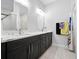 Bathroom featuring double vanity, modern lighting, and minimalist decor at 3390 George Sauls St, Deltona, FL 32738