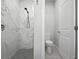 Modern bathroom with white marble shower and grey tile floor, featuring sleek fixtures at 3390 George Sauls St, Deltona, FL 32738