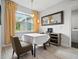 Cozy dining area featuring wood look flooring, contemporary furniture, and natural light from a nearby window at 3390 George Sauls St, Deltona, FL 32738