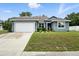 Charming single-story home with a well-manicured lawn, inviting curb appeal, and a spacious two-car garage at 3390 George Sauls St, Deltona, FL 32738