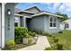 Close-up of the front of a single story home, featuring a landscaped walkway to the front door at 3390 George Sauls St, Deltona, FL 32738