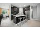 Modern kitchen with dark wood cabinets, stainless steel appliances, a large island, and luxury vinyl plank flooring at 3390 George Sauls St, Deltona, FL 32738