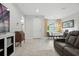 A well lit living area featuring wood look floors, contemporary furniture and decor at 3390 George Sauls St, Deltona, FL 32738