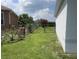 Backyard with a well-maintained lawn, chain-link fence, and some foliage at 343 Marquee Dr, Kissimmee, FL 34758