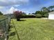 Spacious backyard with lush green lawn and mature trees at 343 Marquee Dr, Kissimmee, FL 34758