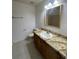 Bathroom with a sink, granite countertop, and a mirror above a wooden cabinet at 343 Marquee Dr, Kissimmee, FL 34758