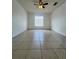 Bedroom featuring tile flooring, a ceiling fan and a window providing natural light at 343 Marquee Dr, Kissimmee, FL 34758