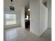 Dining area with tile flooring and views into the kitchen, plus natural light from large window at 343 Marquee Dr, Kissimmee, FL 34758