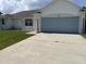 Charming home featuring an attached garage and a well-maintained lawn at 343 Marquee Dr, Kissimmee, FL 34758