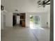 Open living room with tile flooring, ceiling fan and sliding glass doors to the backyard at 343 Marquee Dr, Kissimmee, FL 34758