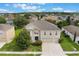 Aerial view of the house showcasing its curb appeal, three-car garage, and landscaping at 364 Fish Hawk Dr, Winter Haven, FL 33884