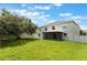 Backyard view featuring a screened patio and grassy yard, surrounded by fencing at 364 Fish Hawk Dr, Winter Haven, FL 33884