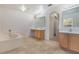 Spacious bathroom with dual sinks, a soaking tub, and neutral tile flooring at 364 Fish Hawk Dr, Winter Haven, FL 33884