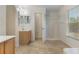 Bathroom featuring a vanity with sink, mirror, tile floor, and walk-in shower at 364 Fish Hawk Dr, Winter Haven, FL 33884