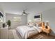 Bright bedroom with a ceiling fan, large window, a bed and a nightstand with lamps at 364 Fish Hawk Dr, Winter Haven, FL 33884