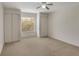 Bright bedroom features neutral carpet, window, two closets, and ceiling fan at 364 Fish Hawk Dr, Winter Haven, FL 33884