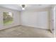 Bedroom featuring neutral carpet, a window allowing natural light in, and direct access to the bonus room at 364 Fish Hawk Dr, Winter Haven, FL 33884