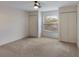 Bright bedroom features neutral carpet, window, two closets, and ceiling fan at 364 Fish Hawk Dr, Winter Haven, FL 33884