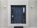 Elegant blue front door with sidelights and classic white trim, enhancing the home's curb appeal at 364 Fish Hawk Dr, Winter Haven, FL 33884