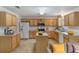 Bright kitchen featuring light wood cabinetry, a center island, modern appliances and adjacent seating at 364 Fish Hawk Dr, Winter Haven, FL 33884