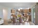 Bright kitchen and breakfast nook featuring light wood cabinetry and a glass topped table set for six at 364 Fish Hawk Dr, Winter Haven, FL 33884