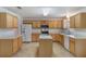 Bright kitchen featuring light wood cabinetry, a center island, and modern appliances at 364 Fish Hawk Dr, Winter Haven, FL 33884