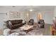 Inviting living room with a leather sofa, comfortable armchairs, and stylish decor at 364 Fish Hawk Dr, Winter Haven, FL 33884