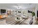 Bright living room features neutral tones, modern decor, large windows and open to the kitchen at 364 Fish Hawk Dr, Winter Haven, FL 33884