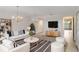 Well-lit living room with elegant chandeliers, modern furniture and a mounted TV at 364 Fish Hawk Dr, Winter Haven, FL 33884