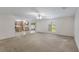 Spacious living area connected to kitchen, bright window and carpet flooring at 364 Fish Hawk Dr, Winter Haven, FL 33884